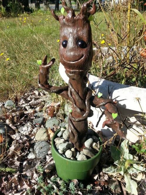 Baby Groot! 12" tall.  Made from 2 packages of $1.25 modeling clay from the dollar store. A $1.00 clay plant pot from a thrift store. Two $1.00 pots of craft paint and two beads!  