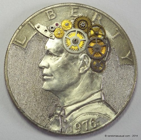 1976 Eisenhower dollar that was really beat up and someone had drilled a 5mm hole in the top of the head. (Just learning to carve coins.) I call it "Put Your Thinking Cap On!".